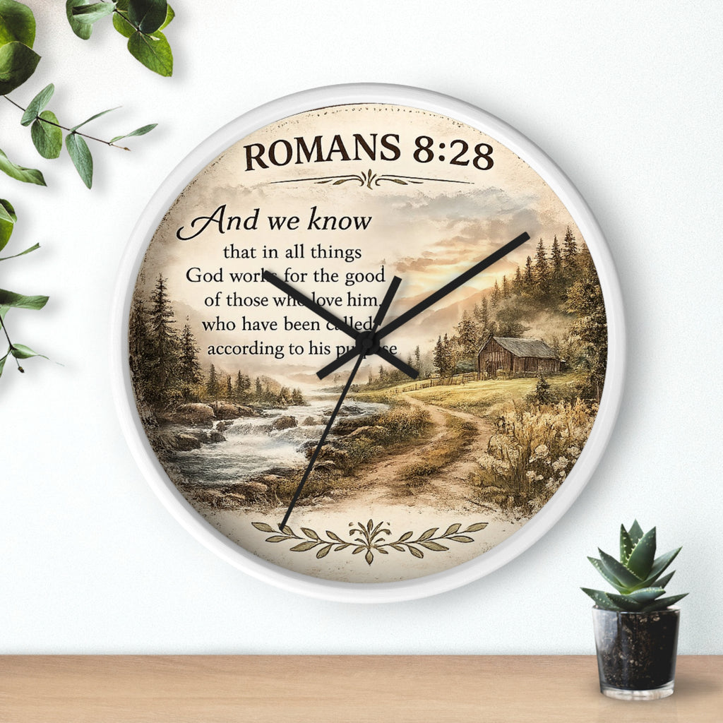 Inspirational Christian wall clock featuring Romans 8:28 scripture with a rustic cabin, flowing creek, and sunset landscape in warm countryside colors.