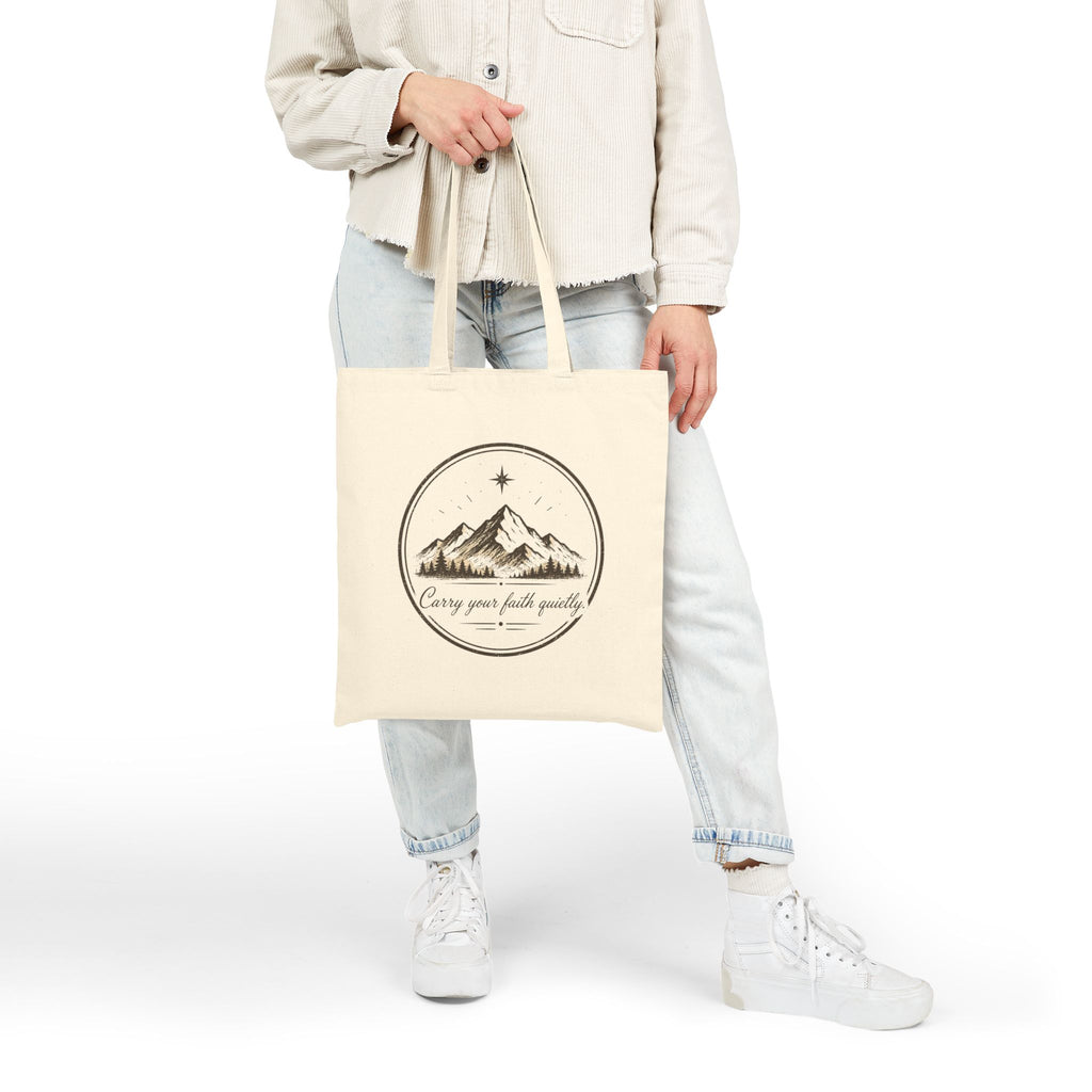 Rustic cotton canvas tote bag featuring mountain peaks, pine trees, a guiding star, and the Faith & Freedom Creations tagline “Carry Your Faith Quietly” in a vintage outdoor-inspired design.