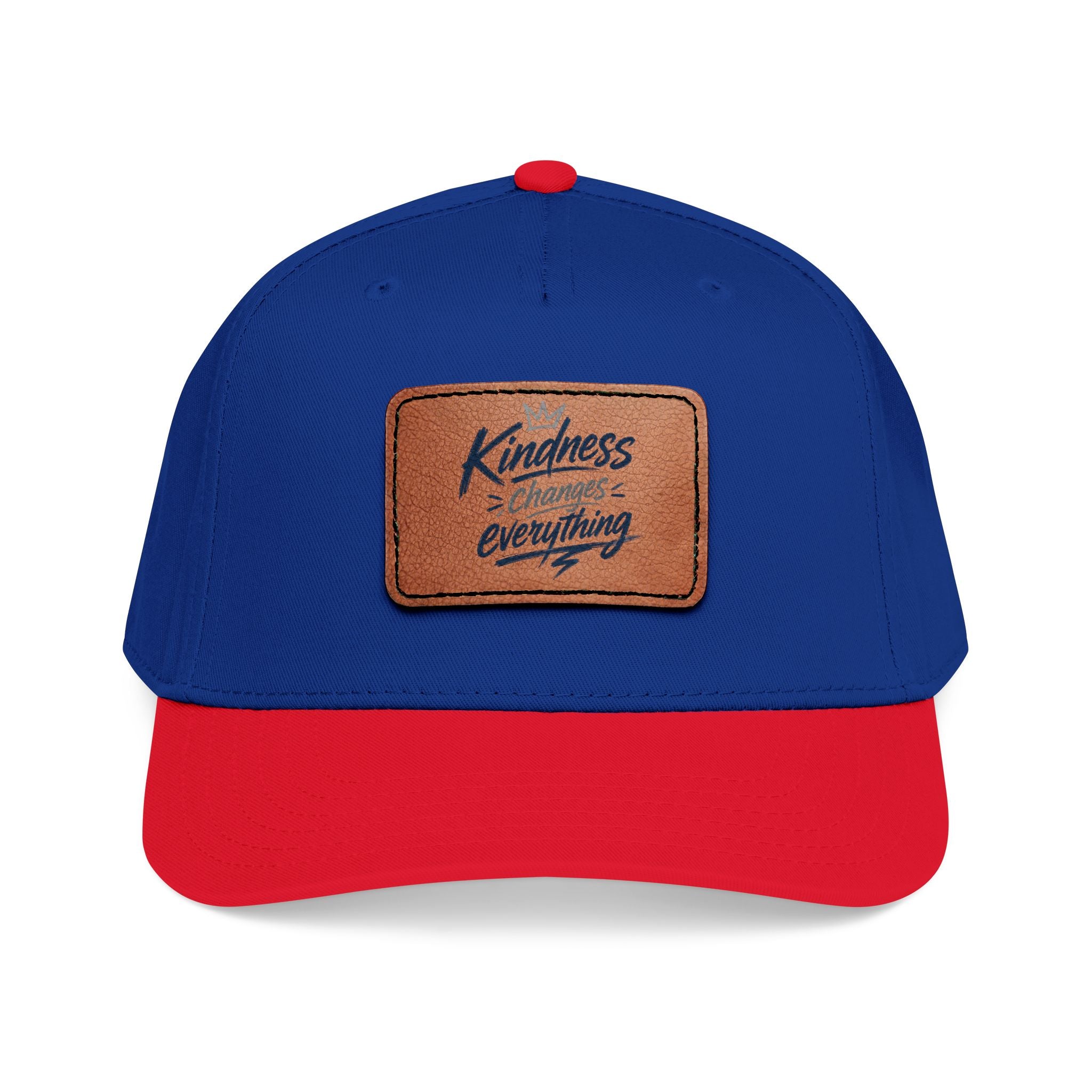 Vintage-inspired baseball cap featuring a brown leather patch with the phrase “Kindness Changes Everything” on a structured mid-profile snapback hat.