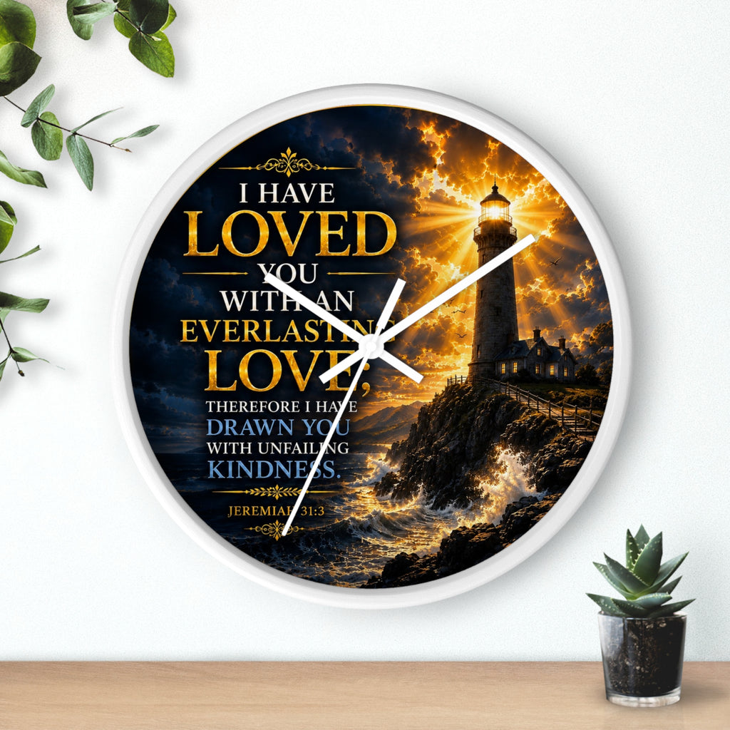 Inspirational Christian wall clock featuring a glowing lighthouse over stormy seas with Jeremiah 31:3 scripture about everlasting love in warm golden tones.