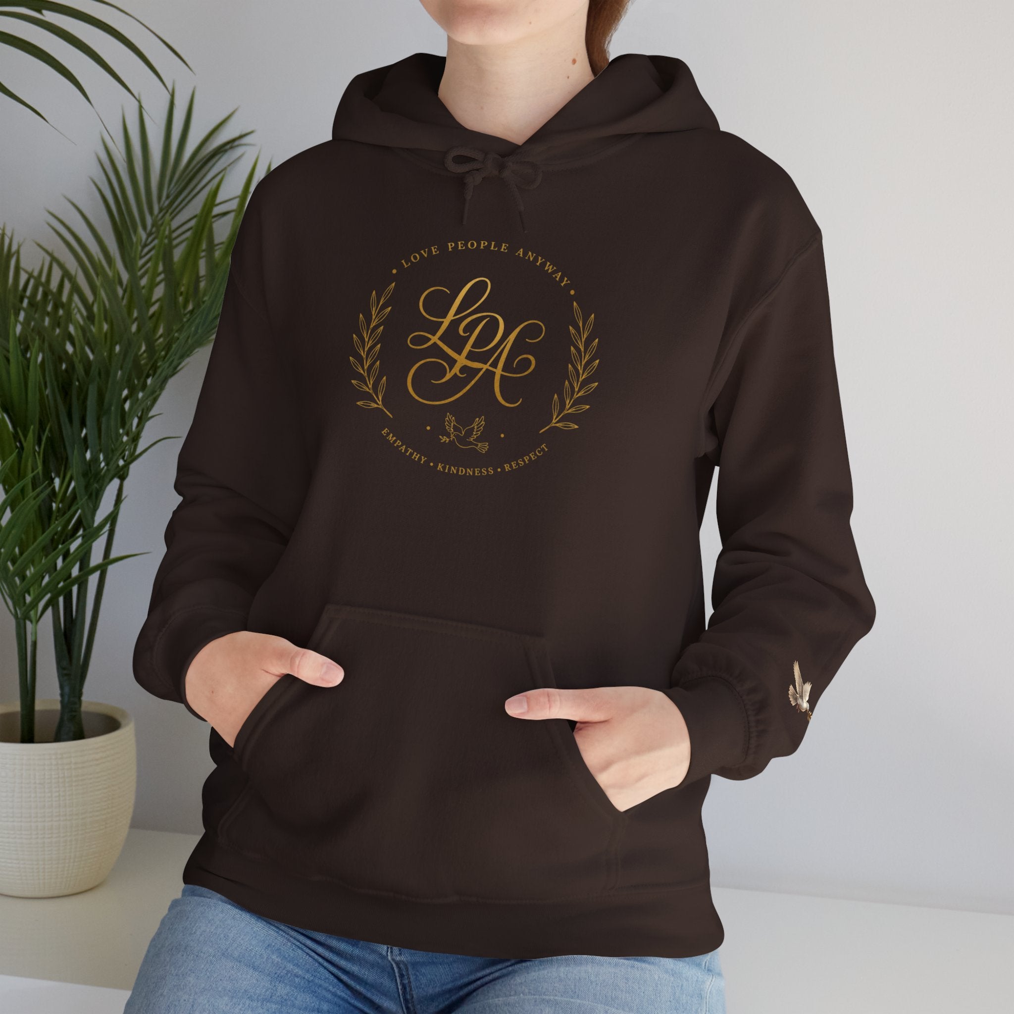 Inspirational Christian hoodie featuring elegant “Love People Anyway” script typography on a soft, cozy hooded sweatshirt designed to encourage kindness and compassion.