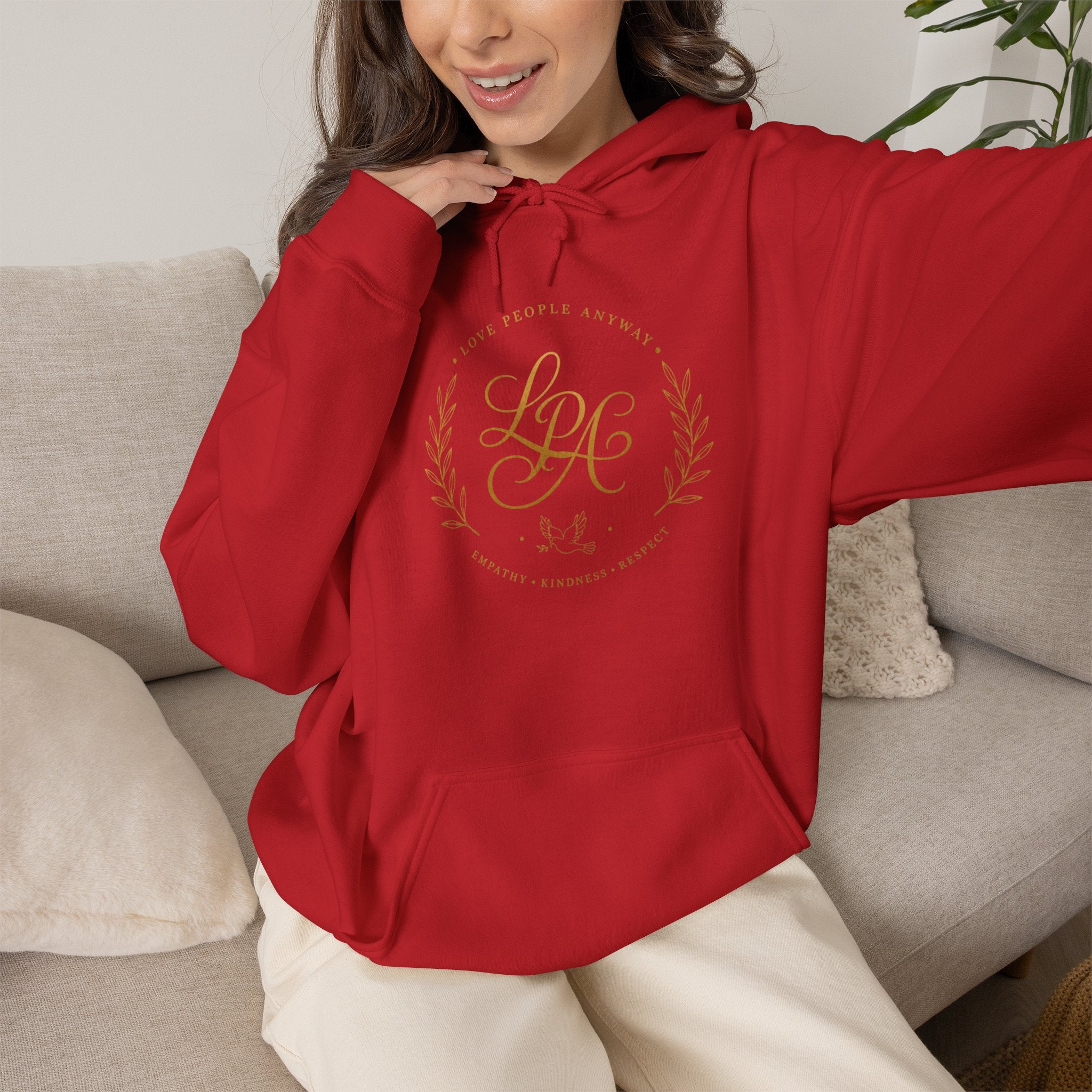 Inspirational Christian hoodie featuring elegant “Love People Anyway” script typography on a soft, cozy hooded sweatshirt designed to encourage kindness and compassion.