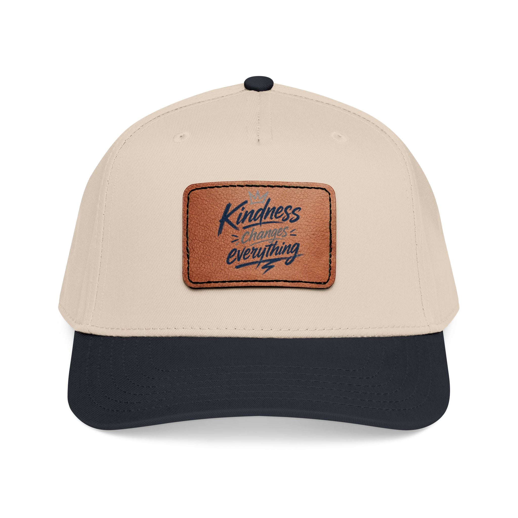 Vintage-inspired baseball cap featuring a brown leather patch with the phrase “Kindness Changes Everything” on a structured mid-profile snapback hat.