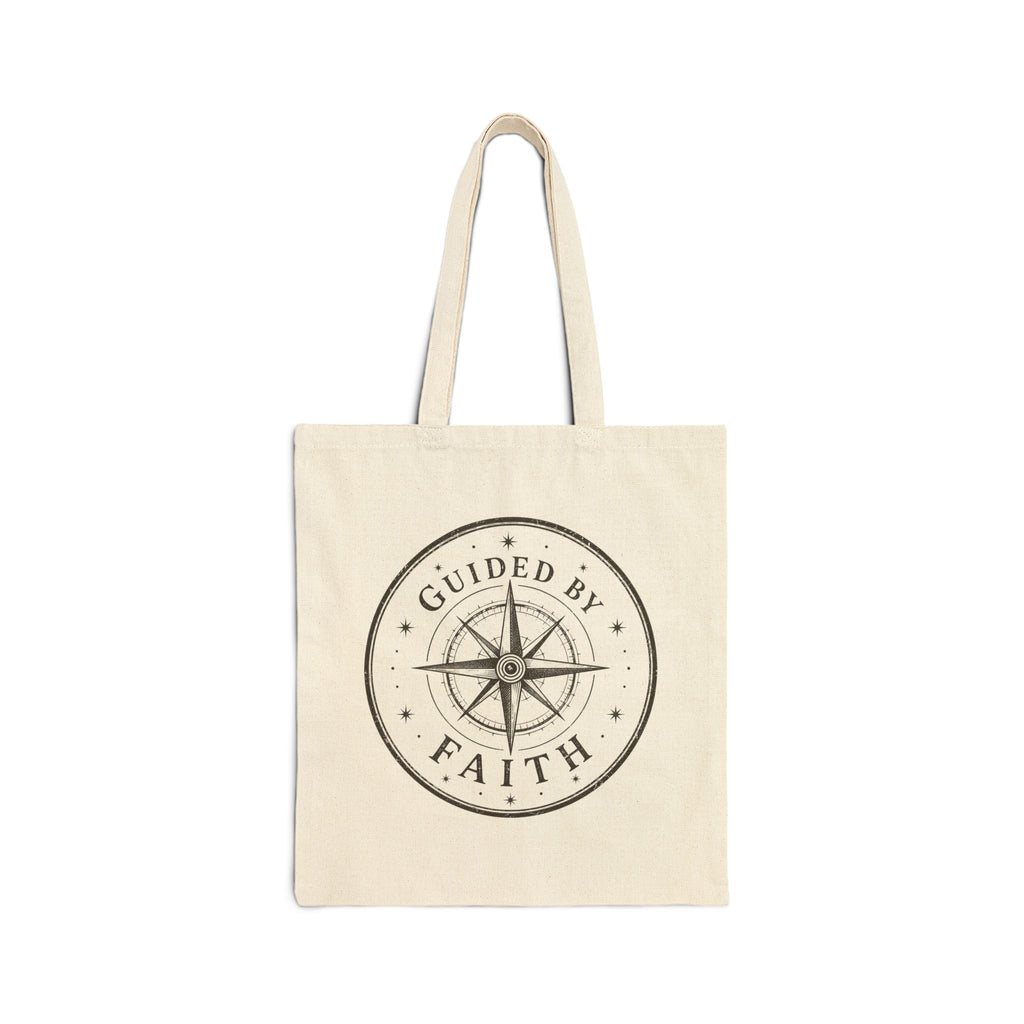 Rustic cotton canvas tote bag featuring a vintage compass rose surrounded by stars and the words "Guided by Faith" in a distressed black-and-cream design.