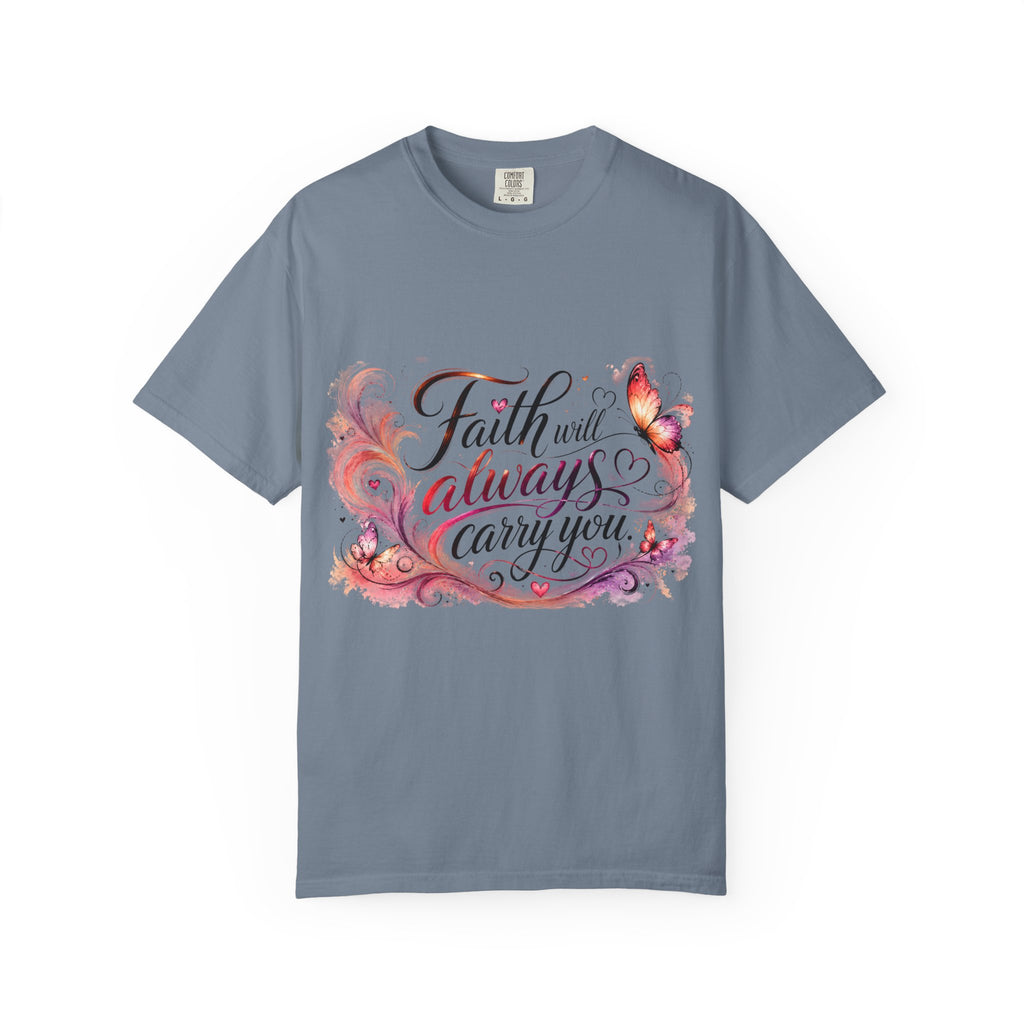 A slate blue crewneck t-shirt featuring a colorful graphic on the front with the text 'Faith will always carry you' in stylized script, decorated with pink, orange, and purple butterflies and floral elements.