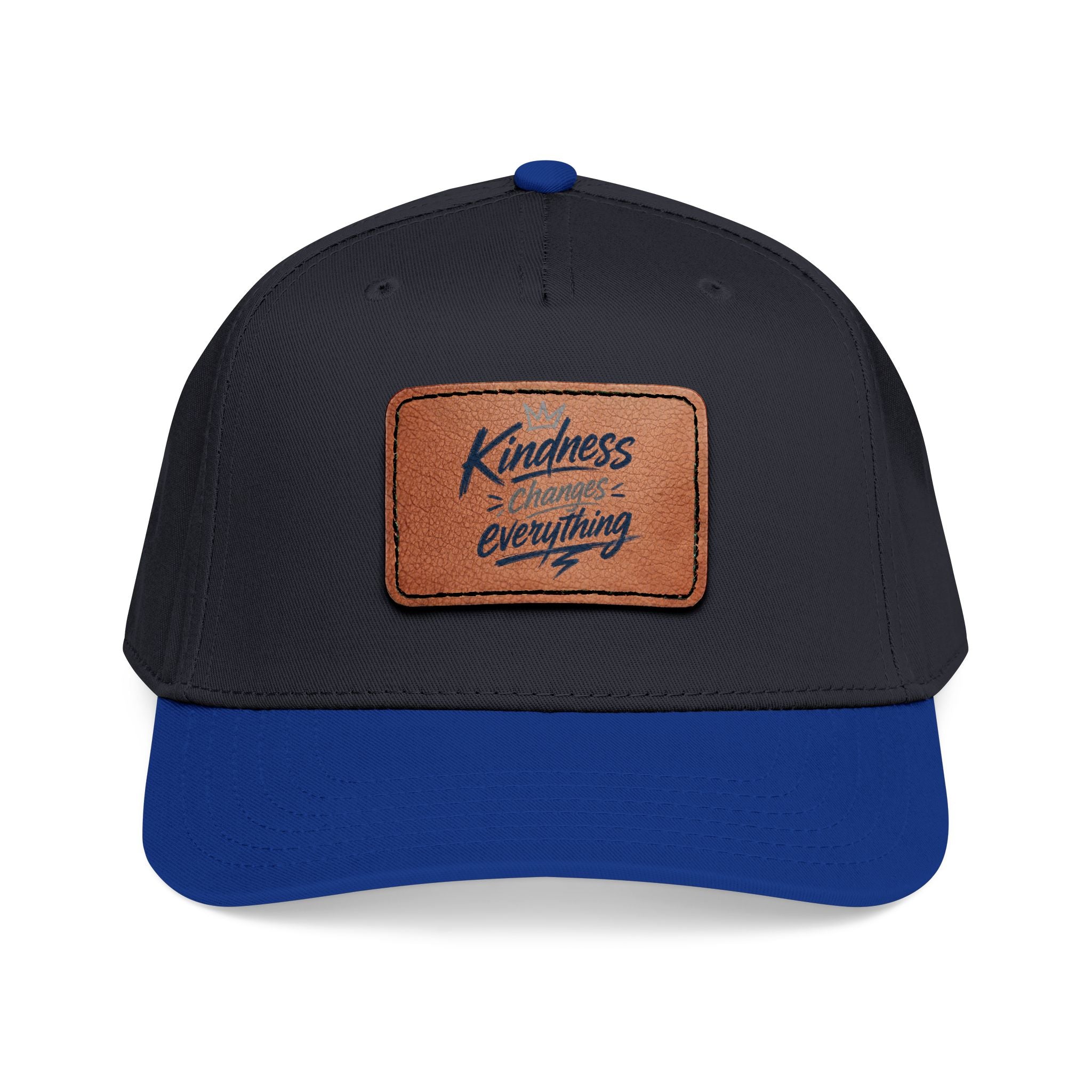 Vintage-inspired baseball cap featuring a brown leather patch with the phrase “Kindness Changes Everything” on a structured mid-profile snapback hat.