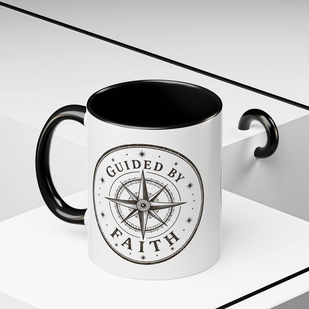 Inspirational ceramic accent coffee mug featuring a compass design and “Guided by Faith” message with colorful handle and interior accents on a glossy white mug.