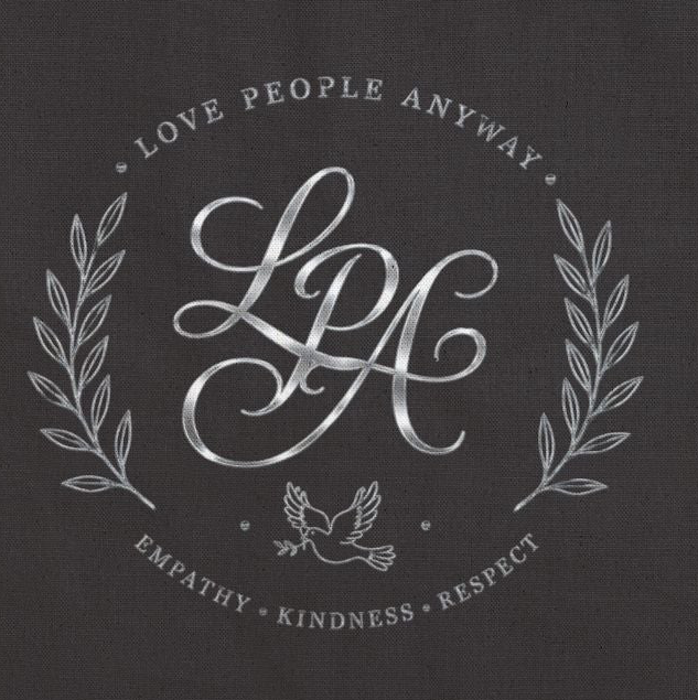 Elegant cotton canvas tote bag featuring a silver monogram crest, laurel branches, dove with olive branch, and the message “Love People Anyway” with empathy, kindness, and respect accents.