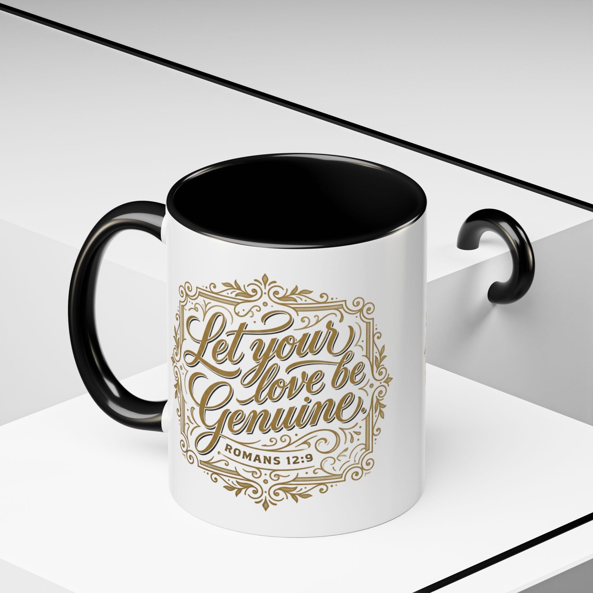 Inspirational ceramic accent coffee mug featuring Romans 12:9 and the message “Let Your Love Be Genuine” in elegant gold script with decorative flourishes and black accent handle and interior.