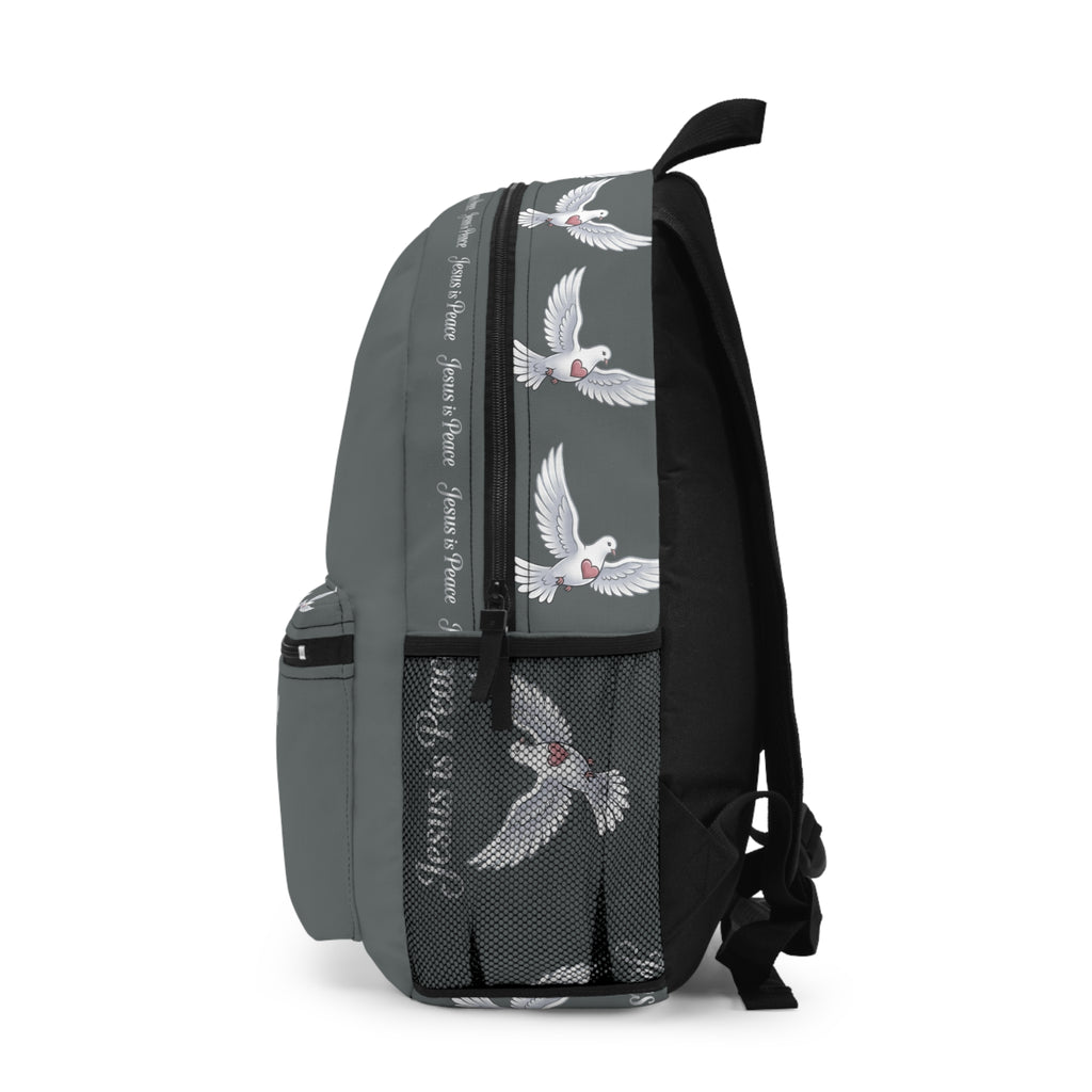 Gray Christian backpack featuring a white dove carrying a heart beneath the words "Jesus Is Peace," with multiple zippered compartments and padded shoulder straps.