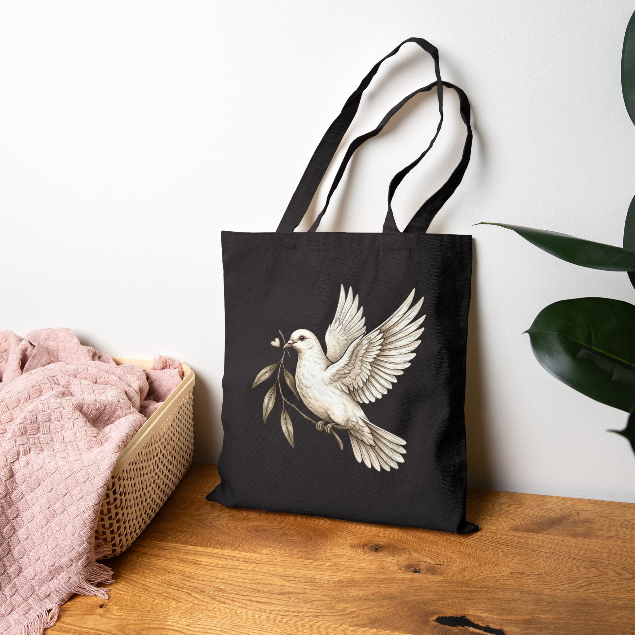 Cotton canvas tote bag featuring a vintage-style dove carrying an olive branch, symbolizing peace, hope, faith, and renewal in a rustic black-and-cream design.