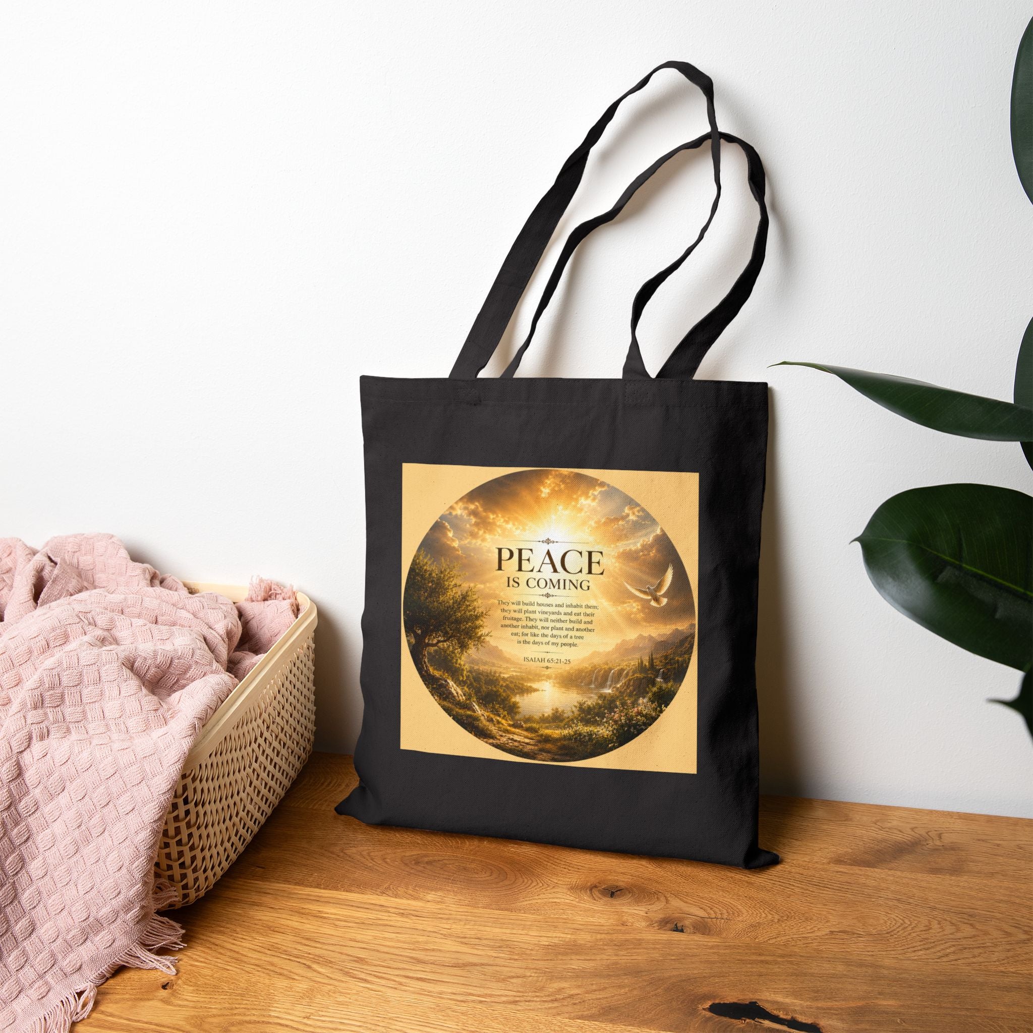 Christian cotton canvas tote bag featuring Isaiah 65:21-25 and the message “Peace Is Coming,” with golden paradise landscape artwork, waterfalls, mountains, river, white dove, and radiant sunlight.