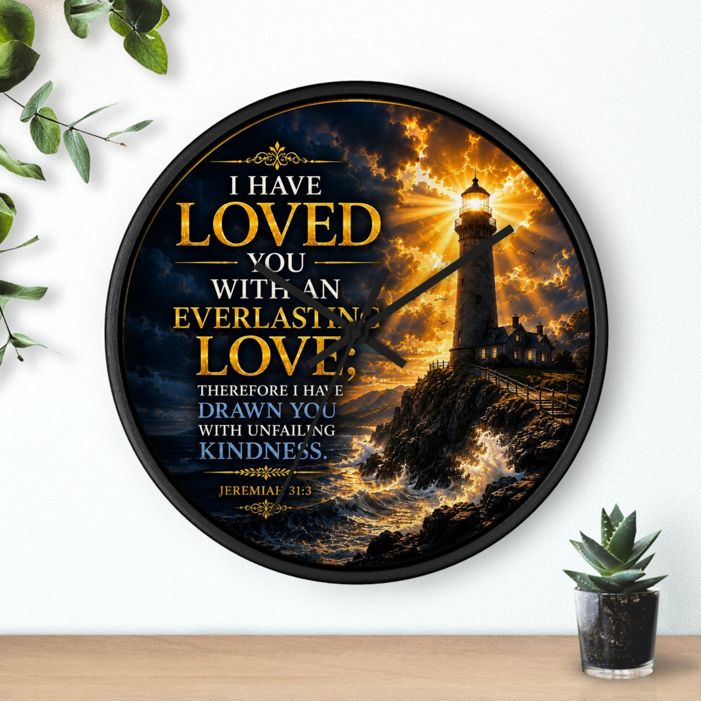 Inspirational Christian wall clock featuring a glowing lighthouse over stormy seas with Jeremiah 31:3 scripture about everlasting love in warm golden tones.