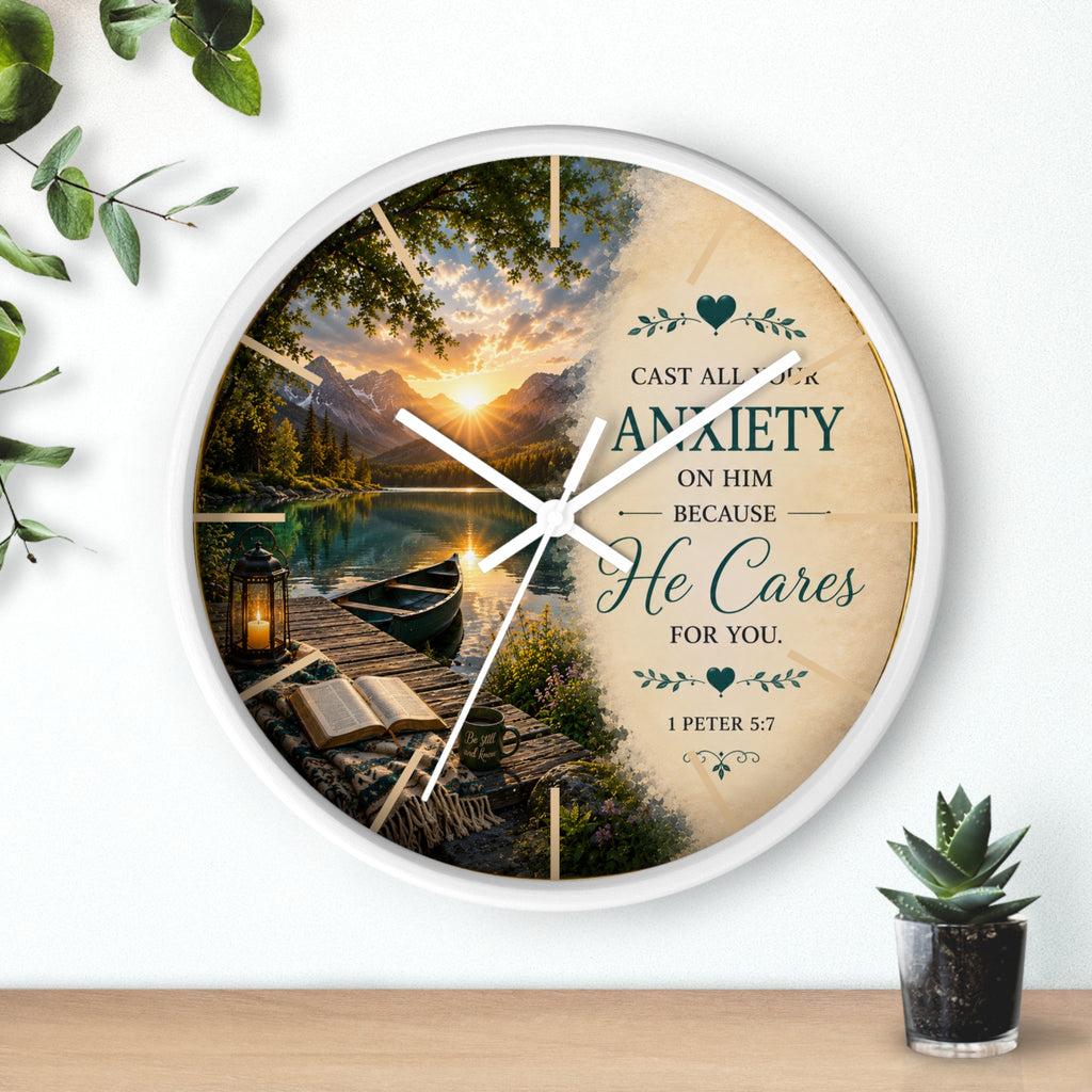 Inspirational Christian wall clock featuring a peaceful lakeside sunrise with a dock, canoe, and 1 Peter 5:7 scripture about casting anxiety on Him.