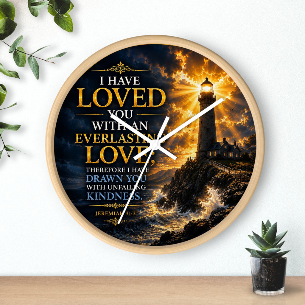 Inspirational Christian wall clock featuring a glowing lighthouse over stormy seas with Jeremiah 31:3 scripture about everlasting love in warm golden tones.
